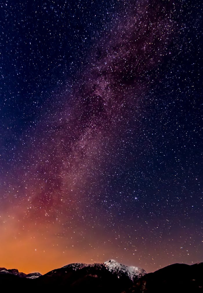 A breathtaking view of the Milky Way captured over a mountain range during a clear night.